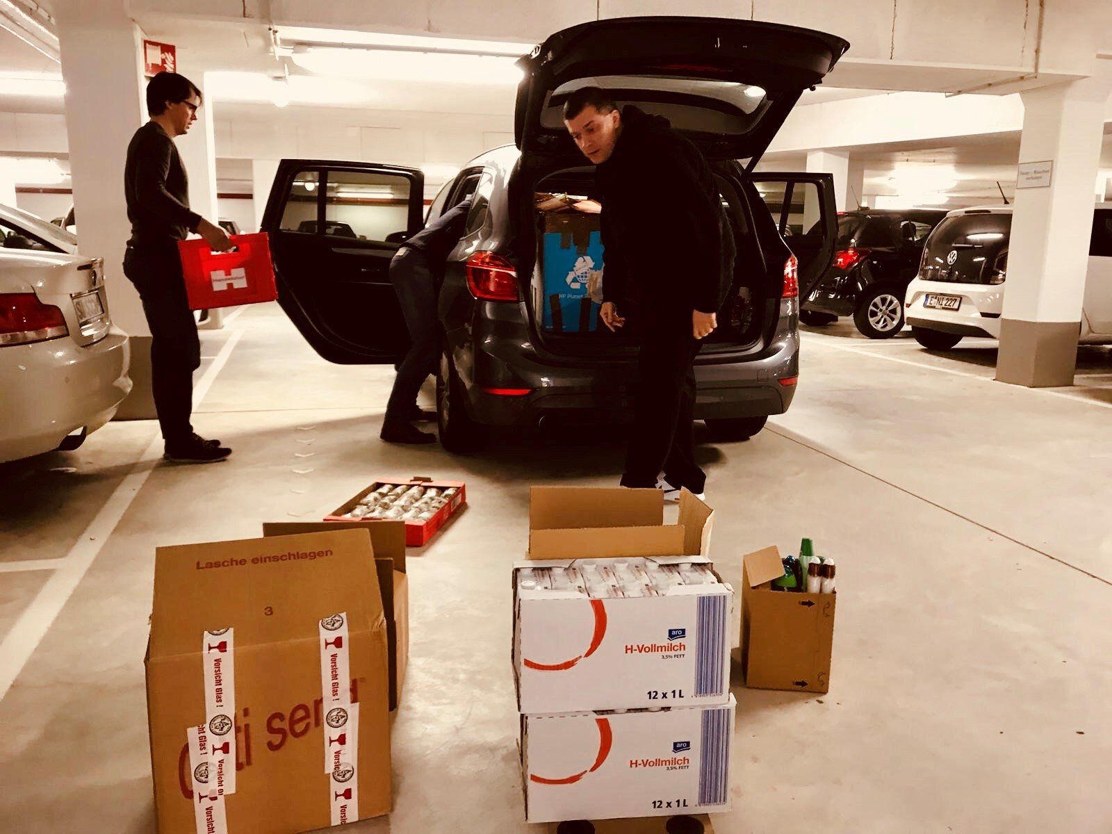 ORAYLIS Mitarbeiter packen Fahrzeug für Weihnachtsspende der Düsseldorfer Tafel