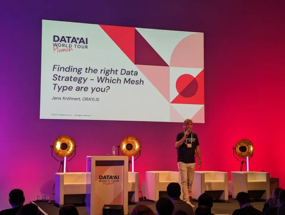 Jens Kröhnert auf der Bühne bei seinem Data-Mesh-Vortrag auf der Data+AI World Tour